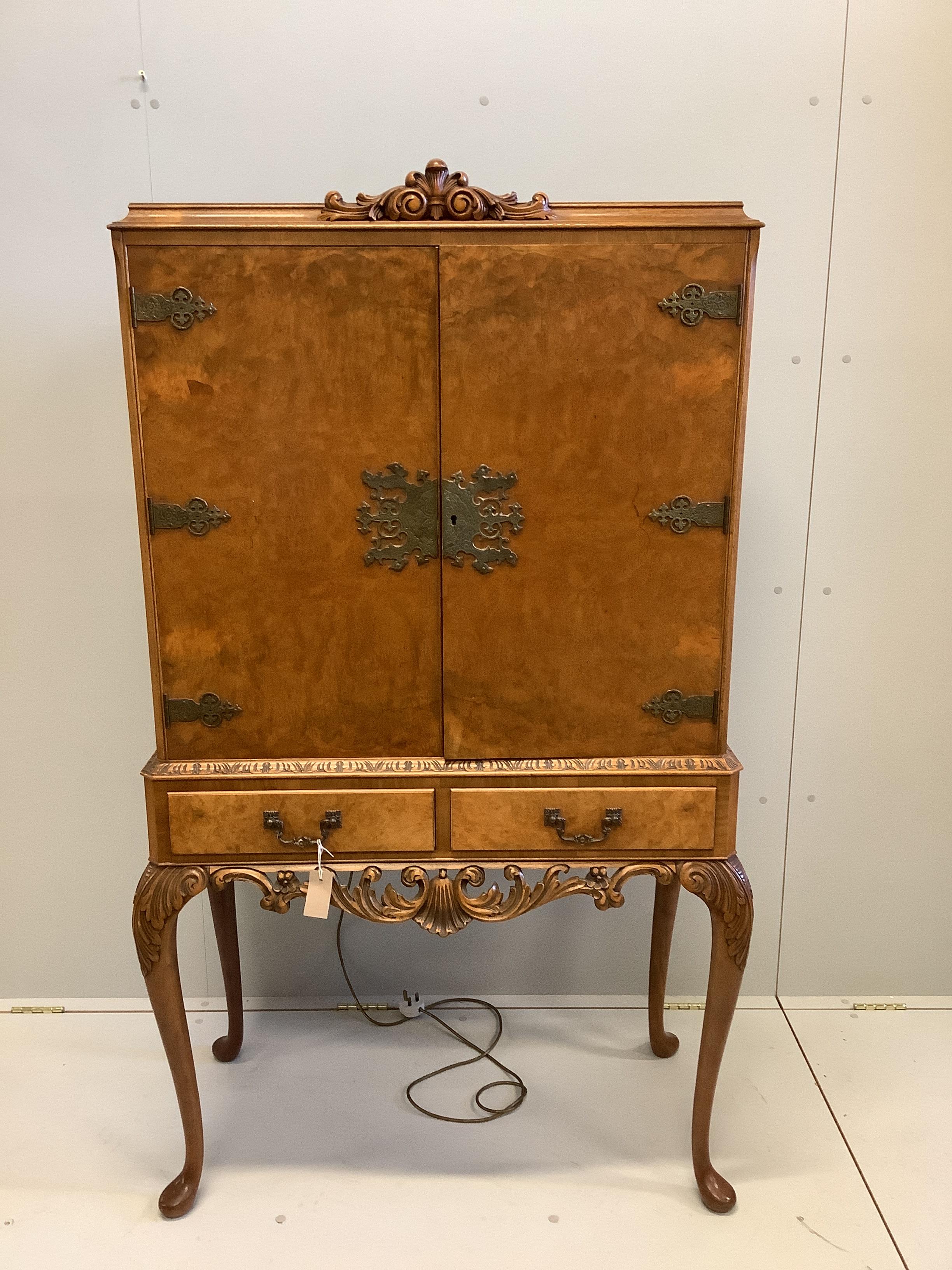 A mid 20th century Queen Anne revival walnut cocktail cabinet, width 94cm, depth 45cm, height 160cm